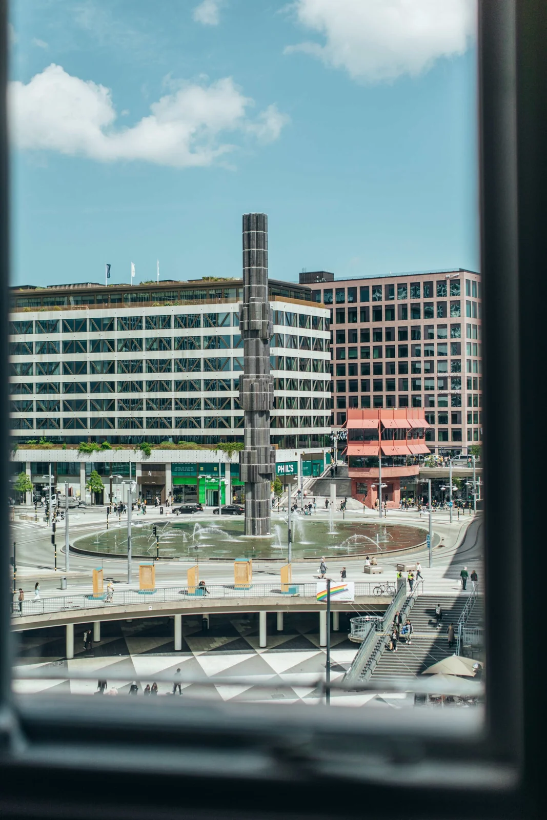 View from United Spaces across Sergels torg, with the fountain, city buildings and people in the square