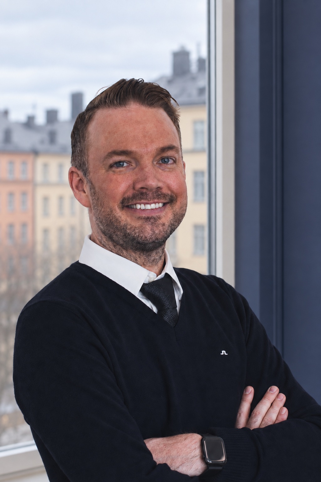 Stefan Christiansson, CEO & Solutions Architect at Nemely, beside a blue-framed window with a city backdrop