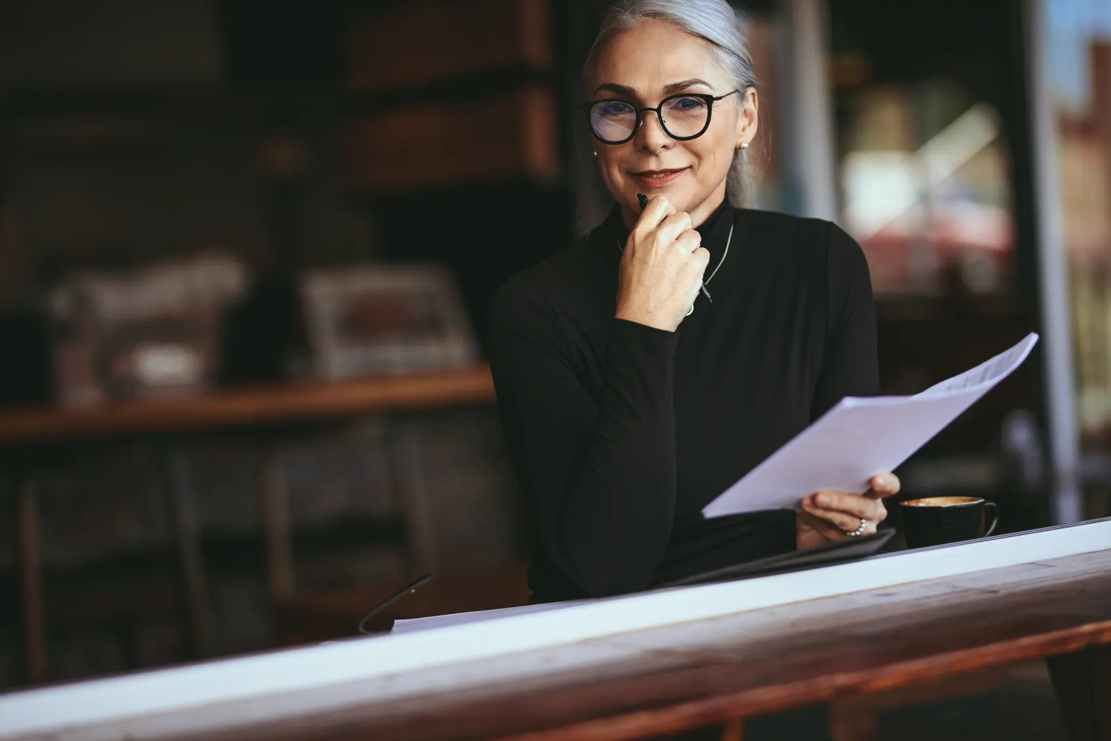 A professional adviser reviewing a document at a desk