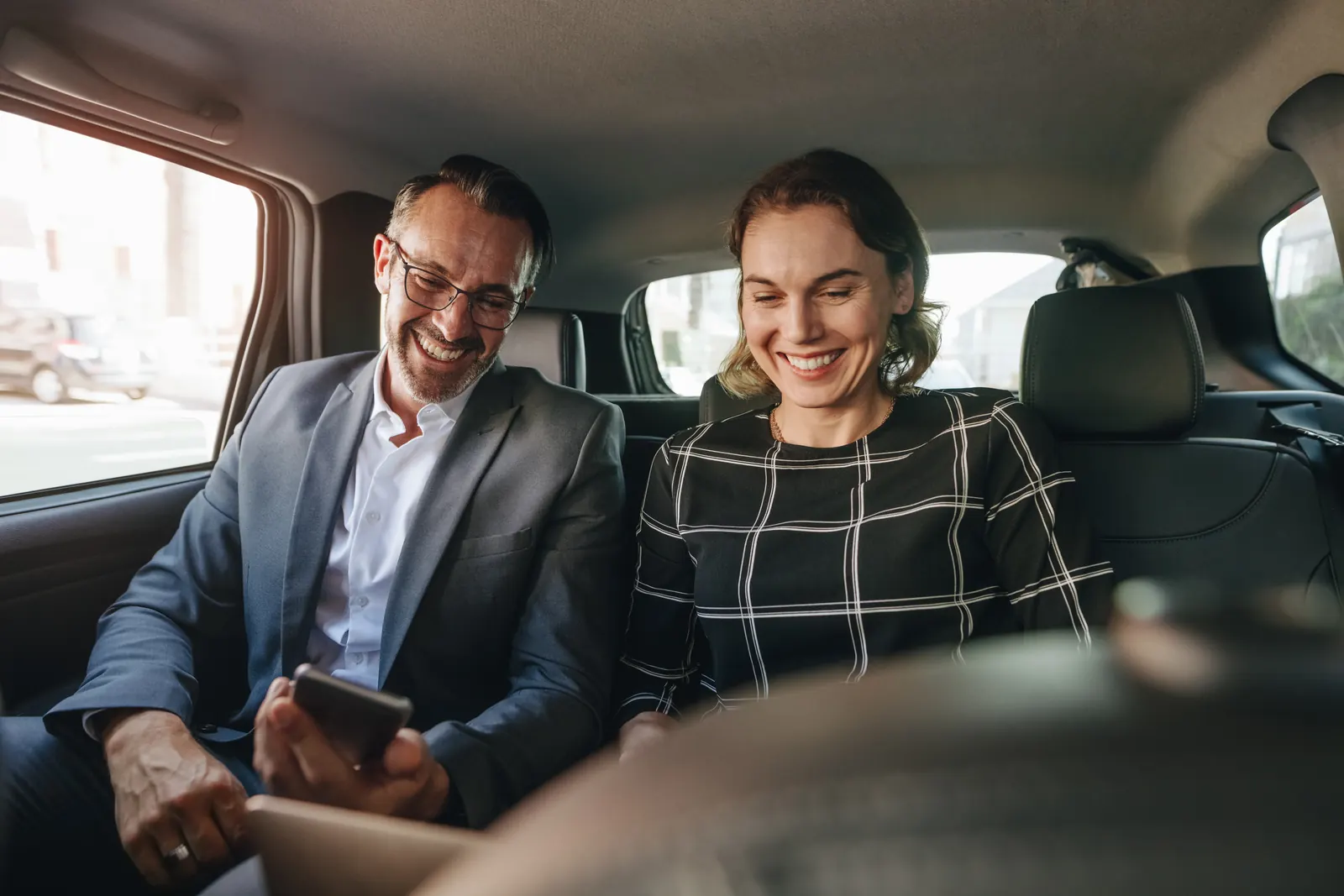 Two business colleagues preparing for a customer meeting while travelling together