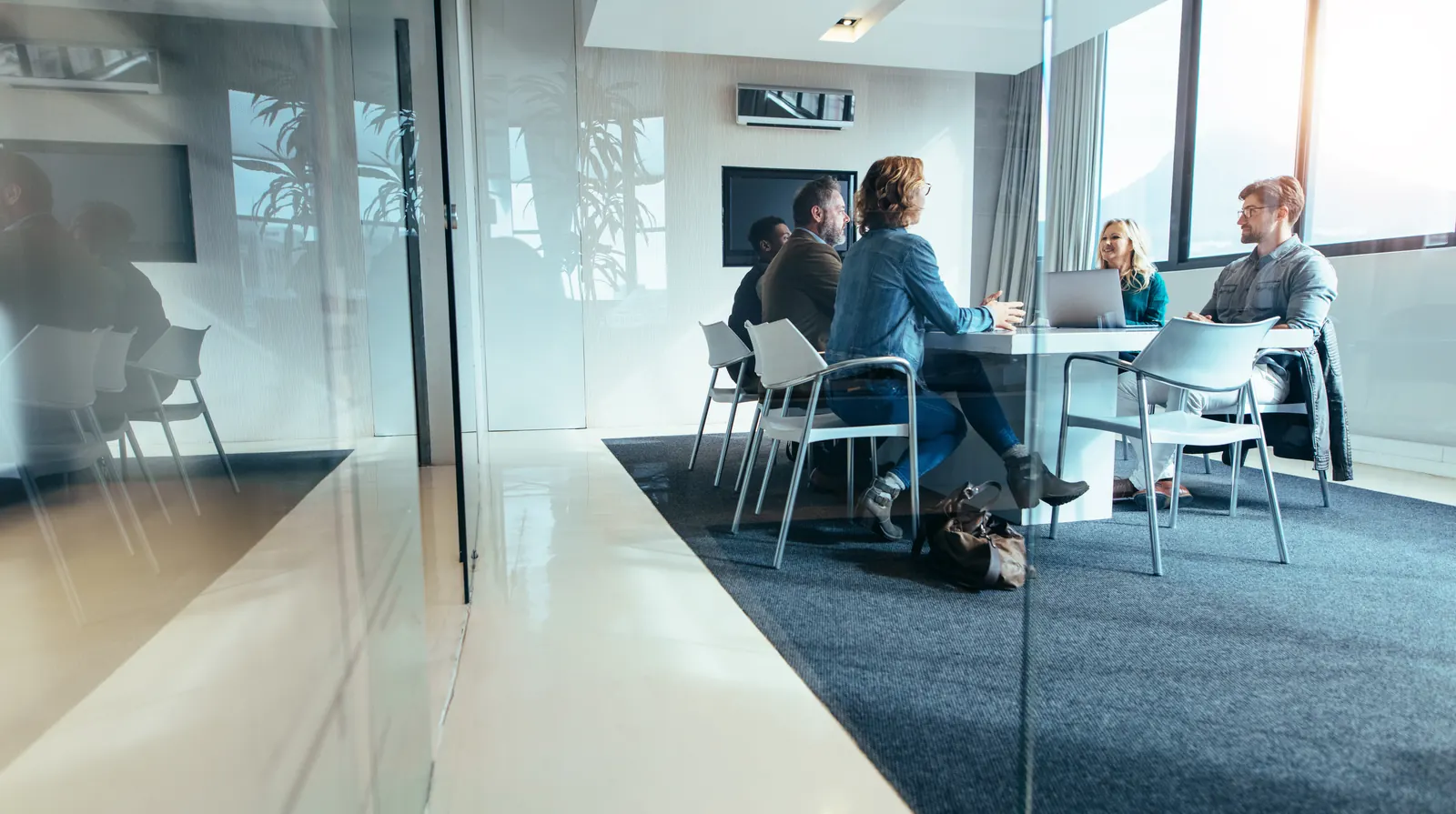 Illustrative stock photograph of colleagues discussing a project together with a laptop