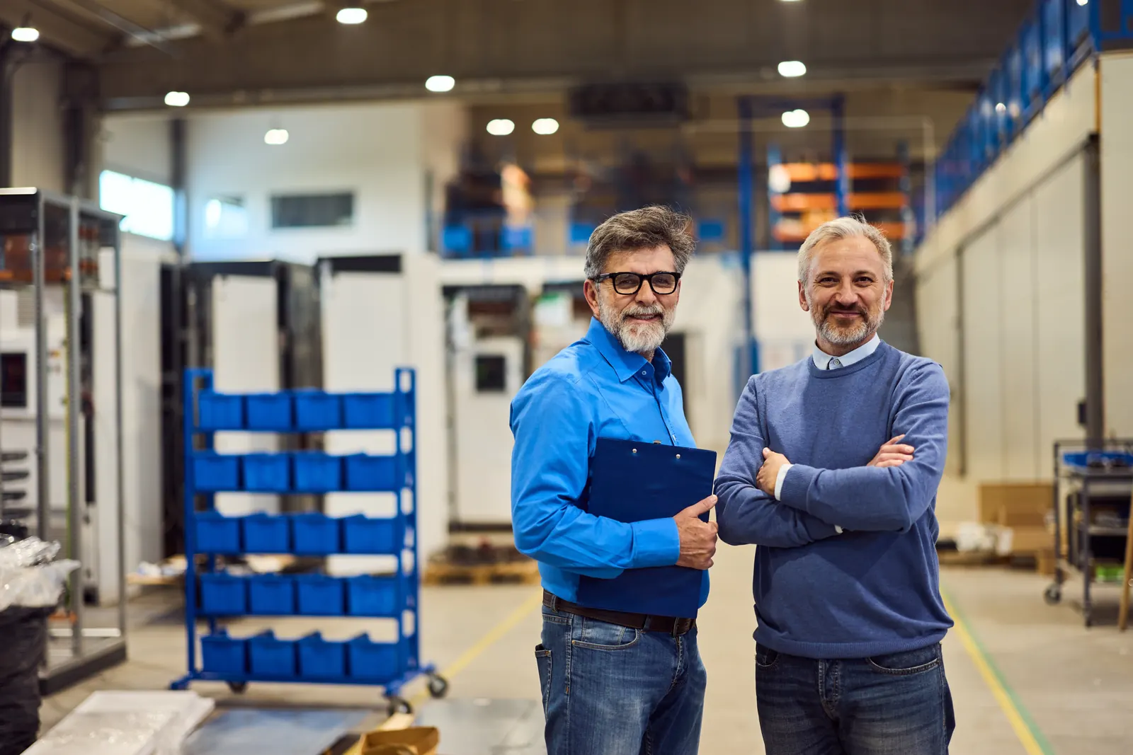 Two industrial colleagues standing in a workshop