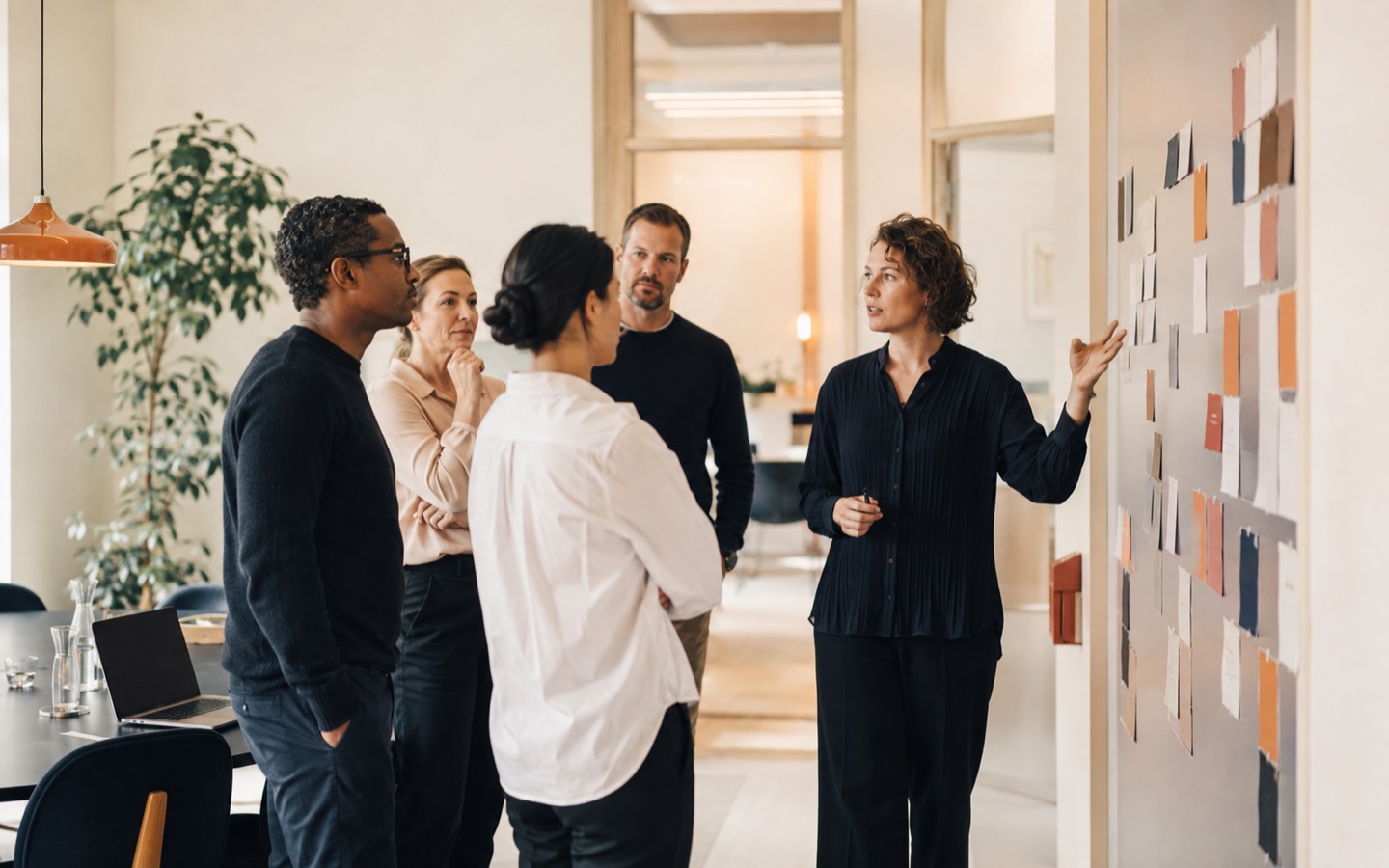 Cross-functional team discussing an organizational change map in a Nordic office