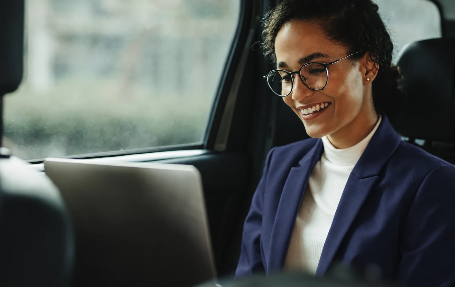 A professional adviser using a tablet beside a window
